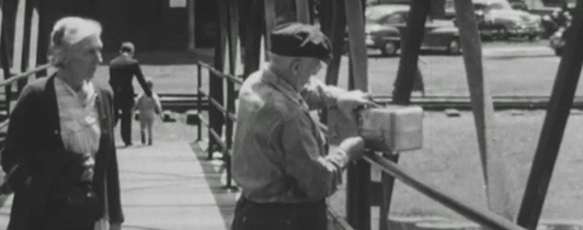 A man and woman standing on a bridge.
