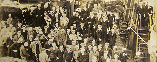 A crowd of sailors on a military vessel.