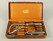 Leather covered case with lid open to show intubation tools arranged inside.
