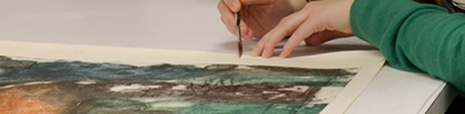 A person repairing a painting.